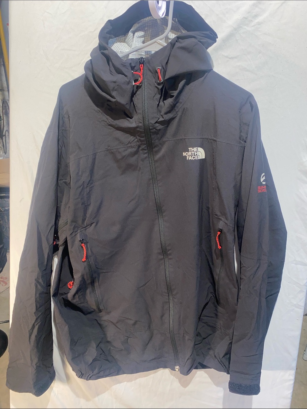 The North Face summit series Men’s Black Hooded Rain Jacket with Red Accents